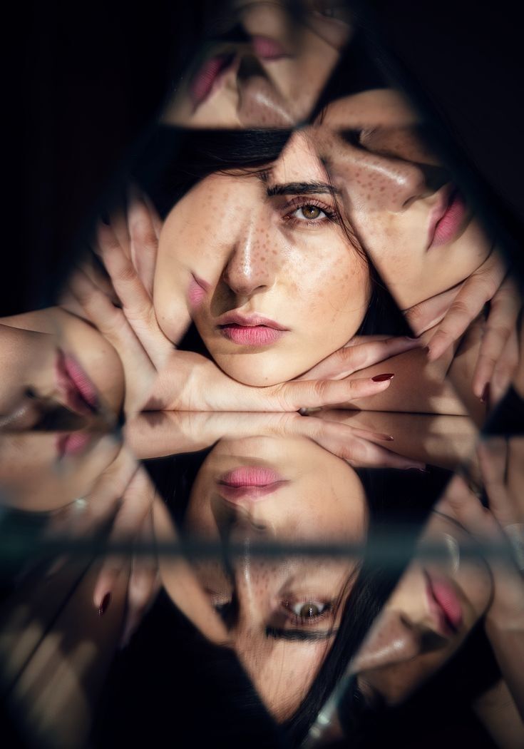 A woman’s face reflected through multiple facets